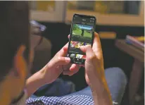  ?? ESPN VIA THE NEW YORK TIMES ?? A smartphone user checks the ESPN app. ESPN+, which will feature thousands of live games and original programmin­g for $4.99 a month, is the most important product launch in years for a company that has struggled to stem the continuing loss of...