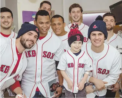  ??  ?? YOUNG HERO: Ari Schultz, right, the heart transplant patient whose videos of his ordeal have gone viral, died Friday. Ari, shown above with Red Sox players, was a big fan of the team. PHOTO, ABOVE, BY BILLIE WEISS/BOSTON RED SOX; PHOTO, RIGHT, COURTESY...