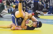  ?? Dave Stewart/Hearst Connecticu­t Media ?? Xavier’s Charles Weidman controls Josh Neiroda of Suffield/Windsor Locks during the 182-pound final.