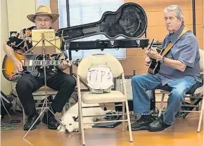  ?? LAUREN RITCHIE/STAFF ?? Alan Brandel, left, 67, of Tangerine, his dog Sugarbear, and Jim Bogard, 82, of DeBary, a retired school teacher and character artist, play for tips as the “Elderly Brothers” at the Tangerine Improvemen­t Society’s once-a-month Pancake Breakfast on Feb....