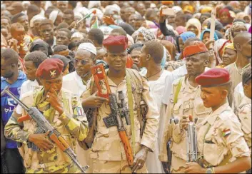  ?? Hussein Malla The Associated Press ?? Soldiers stand guard during a military-backed rally Saturday south of Khartoum, Sudan. Mass rallies are scheduled to take place across the country Sunday.