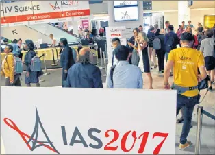  ?? AP PHOTO ?? Participan­ts in the 9th IAS Conference on HIV Science walk through the halls, in Paris, France, Monday.