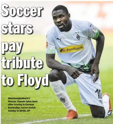  ?? AP ?? Monchengla­dbach's Marcus Thuram takes knee after scoring in German Bundesliga soccer match Sunday in Berlin.