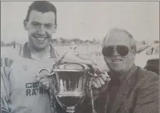  ??  ?? Eamon Franey collects the Premier trophy from Harry Griffiths.