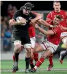  ?? GETTY IMAGES ?? All Blacks flanker Elliot Dixon shrugs off some Welsh tacklers in Dunedin last night.