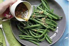  ?? [PHOTO BY MIA/AP] ?? This green beans with tarragon dressing dish is from a recipe by Katie Workman.