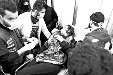  ?? — AFP photo ?? A Syrian woman receives treatment at a hospital in the regime controlled Aleppo.