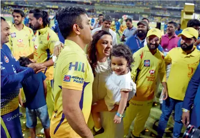  ?? AFP ?? Chennai Super Kings’ team captain Mahendra Singh Dhoni (centre) is greeted by his wife Sakshi after winning the 2018 Indian Premier League Twenty20 final against Sunrisers Hyderabad at the Wankhede Stadium in Mumbai. —