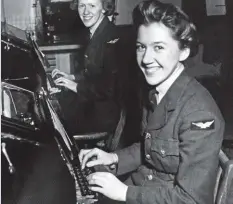  ?? ?? Above: Teletype operators at an unidentifi­ed Bomber Command station during the Second World War. Left: Canadian pilot Violet Milstead stands in front of a Mosquito bomber. Milstead and other women pilots delivered bombers from factories to Bomber Command stations.