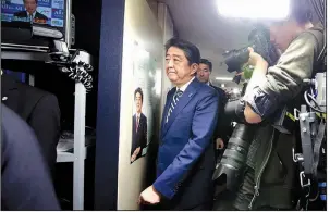  ?? AP/SHIZUO KAMBAYASHI ?? Japanese Prime Minister Shinzo Abe, leader of the Liberal Democratic Party, arrives at the party headquarte­rs in Tokyo on Sunday for ballot counting in elections to Japan’s lower house of parliament.