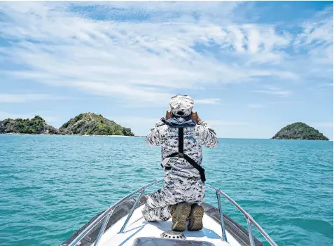  ?? ?? A member of the Malaysian Maritime Enforcemen­t Agency during the search, above, and diving instructor Kristine Grodem after being rescued, left