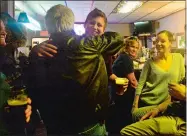  ?? SARAH GORDON/THE DAY ?? Emily Cichon, right, of Groton hugs fellow regular customer Ed Crotty during the last night at John’s Mystic River Tavern on Tuesday.