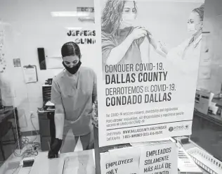  ?? LM Otero / Associated Press ?? A Dallas County Health and Human Services nurse completes paperwork after administer­ing a Pfizer COVID-19 vaccine, the shot that recently received full approval from the FDA.