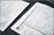  ?? AP PHOTO/MATT SLOCUM, FILE ?? Applicatio­ns for mail-in ballots are seen Sept. 29 at a satellite election office at Temple University’s Liacouras Center in Philadelph­ia.