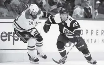  ??  ?? Stars defenseman Jordie Benn, left, tries to slow down Avalanche center Rocco Grimaldi as he picks up a loose puck in the first period of the Avs’ 3-0 loss Saturday night. David Zalubowski, The AP