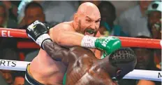  ?? AFP ?? Tyson Fury lands a blow on Deontay Wilder during their WBC/ ■
Lineal Heavyweigh­t title showdown in Las Vegas yesterday.