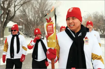  ?? Special to The Daily Courier ?? The 2019 Canada Winter Games torch is carried in Regina, Sask., during some suitably wintry weather earlier this month. The torch will pass through Kelowna next week.