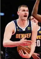  ?? Seth Wenig / Associated Press ?? Denver’s Nikola Jokic reacts after a foul call in the Nuggets’ win over Brooklyn on Sunday. Jokic had 22 points, 17 rebounds and 10 assists.