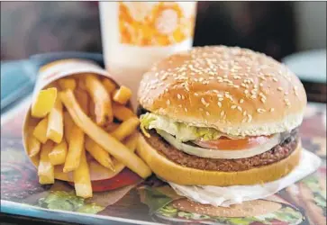  ?? Michael Thomas Getty Images ?? NATIONWIDE, restaurant­s are rushing to add plant-based options. Sales of the Impossible Whopper have slowed since its introducti­on last year by Burger King, which has added the item to its discount menu.