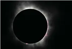  ?? ?? The moon covers the sun during a total solar eclipse, as seen April 8 from Fort Worth. (AP photo/lm Otero)