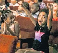  ?? JACOB LANGSTON/ORLANDO SENTNEL ?? Schoolchil­dren from throughout Orange County cheer the Orlando Philharmon­ic and ballet at the The Bob Carr Theater on Tuesday.