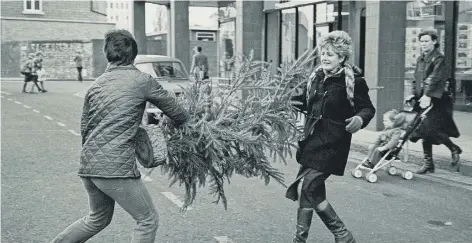  ??  ?? Who was carrying the tree - and who is that crossing the road pushing a buggy?