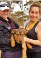  ?? — AFP ?? Jubilant runners hold a dog called Stormy after it completed the Goldfields Pipeline marathon.