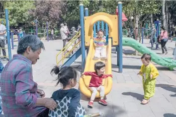  ?? GILLES SABRIE/THE NEW YORK TIMES ?? Children play at a park Tuesday in Beijing. Effective this week, China will now allow couples to have three children.
