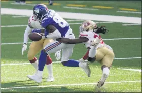  ?? COREY SIPKIN — THE ASSOCIATED PRESS ?? San Francisco 49ers’ Marcell Harris, right, knocks the ball away from New York Giants’ Darius Slayton during the second half of the 49ers’ 36-9 win at East Rutherford, N.J., on Sunday, Sept. 27.