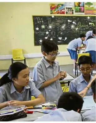  ??  ?? To encourage students to focus on their own learning, instead of the competitio­n, report books will no longer state the student’s ranking in his class and level.— Photos: The Straits Times/Asia News Network