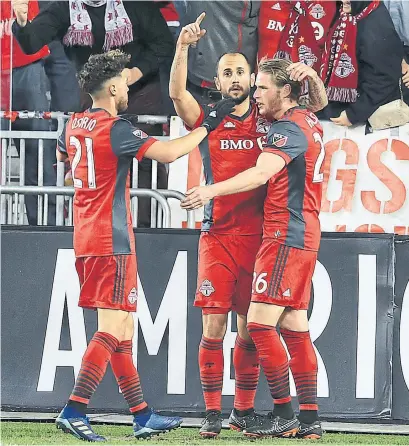  ?? RENE JOHNSTON/TORONTO STAR ?? Victor Vasquez, centre, celebrates with Jonathan Osorio and Nicolas Hasler after opening the scoring against Philadelph­ia Friday.