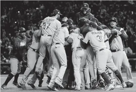  ??  ?? Dodgers players celebrate after winning Game 5 over the Cubs on Thursday in Chicago.