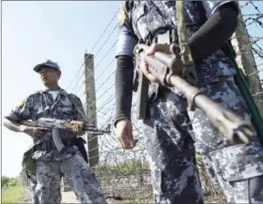  ?? YE AUNG THU/AFP ?? Armed Myanmar border police patrol along the river dividing the Myanmar and Bangladesh border in Maungdaw, Rakhine state, on October 15.