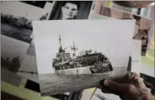  ?? DARREN CALABRESE, THE CANADIAN PRESS ?? Clockwise from above:George Borgal holds an archival photo of HMCS Saguenay in his home in Halifax. HMCS Saguenay was hit by torpedo fire in December 1940, but still managed to steam almost 450 kilometres, backwards, to port at Barrow-in-Furness, England.A Canadian sailor looks out across the North Atlantic at a warship in 1944.HMCS Saguenay showing damage from the torpedo strike.