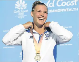  ??  ?? Grace Reid enjoys her time on the podium after winning Scotland’s first diving gold medal for 60 years. Picture: PA.