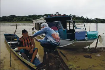  ?? EDMAR BARROS — THE ASSOCIATED PRESS ?? Luis Alves Nogueira, 74, left, receives a dose of the Oxford-AstraZenec­a COVID-19 vaccine from a health care worker in the Pupuri community along the Purus River in the Labrea municipali­ty, Amazonas state, Brazil, on Friday.