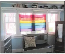  ?? Special to the Democrat-Gazette/ KIM DISHONGH ?? A Pride flag hangs in a window of the Pink House, with the sun lighting up its rainbow of colors.