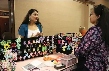  ?? Signal file photo ?? Meghna Churi, left, shows Cathy Gregory the accessorie­s she has for sale at the Elks Lodge event in 2017.