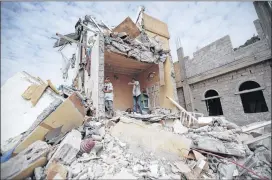  ?? HANI MOHAMMED / ASSOCIATED PRESS ?? Boys stand in the rubble of a house in Sanaa, Yemen, that was destroyed in August by Saudi-led airstrikes. Yemen has been devastated over the past two years by a civil war that sprang from a rebellion by Shiite Houthis.