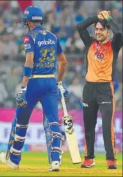  ?? AFP ?? Sunrisers Hyderabad's Rashid Khan (right) reacts after a missed opportunit­y against Mumbai Indians’ Hardik Pandya on Tuesday.