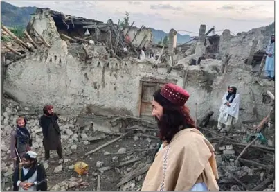  ?? (AP/Bakhtar News Agency) ?? Afghans assess the destructio­n caused by an earthquake Wednesday in Paktika Province in eastern Afghanista­n, a remote area near the border of Pakistan. People dug through the rubble with their bare hands to search for victims.