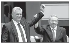  ??  ?? Cuba’s new president Cubadebate via AP/IRENE PEREZ
Miguel Diaz-Canel (left) and former president Raul Castro raise their arms after Diaz-Canel was elected as the island nation’s new president on April 19 at the National Assembly in Havana, Cuba.