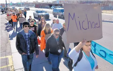  ?? GREG SORBER/JOURNAL ?? Rebekah Najar holds a sign with the name of a homeless person who died in 2016. She and about 100 others, many also carrying signs, participat­ed in the annual Homeless Persons’ Memorial Vigil on Wednesday.