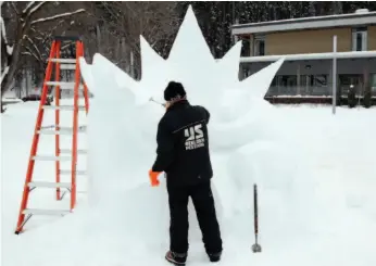  ?? CITIZEN FILE PHOTO ?? John McKinnon of Nelson meticulous­ly scrapes away snow as he creates a sculpture during last year’s Downtown Winter Carnival.