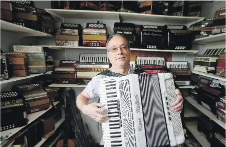  ?? ADRIAN LAM, TIMES COLONIST ?? Tempo Trend owner Martin Hertgt in the accordion section at his Victoria store.