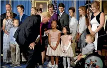  ?? PHOTO: REUTERS ?? US President Donald Trump greets families who he said had been negatively affected by the Affordable Care Act, in the Blue Room of the White House yesterday.