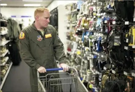  ?? THE ASSOCIATED PRESS ?? Staff Sgt. Alex Frank shops at the Military Uniform store within the Exchange, at Offutt Air Force Base, Neb. Starting in fall 2017, all honorably discharged veterans will be eligible to shop tax-free online at the Exchange with the same discounts they...