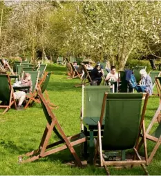  ??  ?? Visitors relax outside The Orchard tearoom.