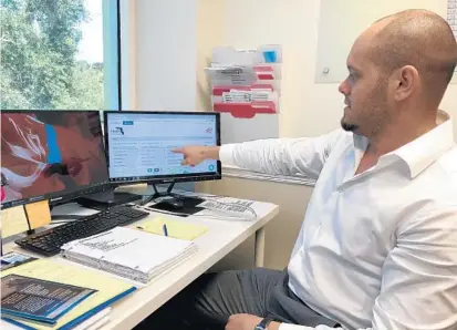  ?? NASEEM S. MILLER/ORLANDO SENTINEL ?? Aldrick Mesa, director of clinical operations at Kassy Home Health, explains how he uses Caredove to locate find services for the firm’s clients.
