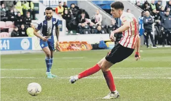  ?? ?? Ross Stewart scores for Sunderland against Wigan from the penalty spot. Picture: Frank Reid.